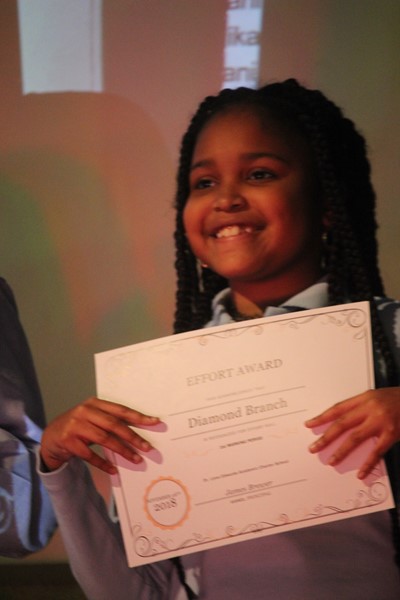 Diamond, 5th grade proudly holds her award.